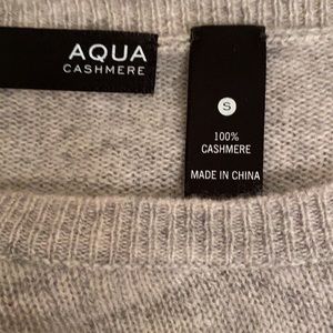 Comfy cashmere sweater with blue eyed zebra on it.